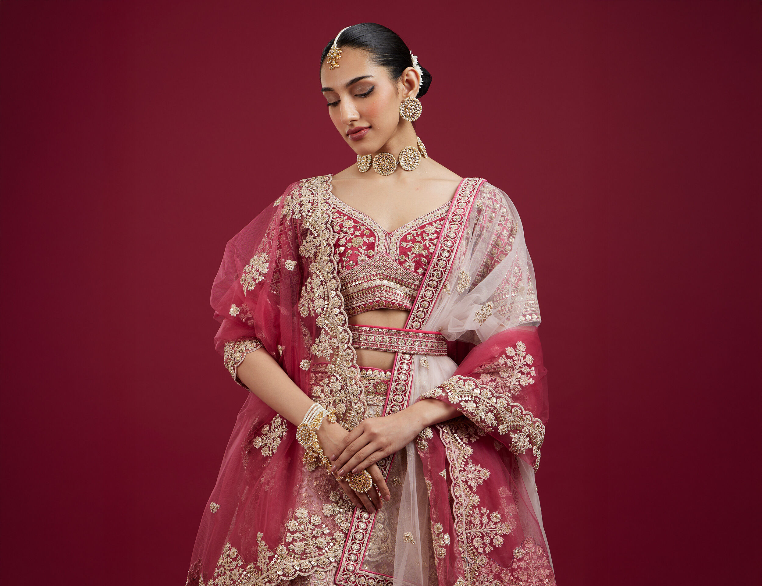 Women flaunting her jewellery matching with her pink designer lehenga